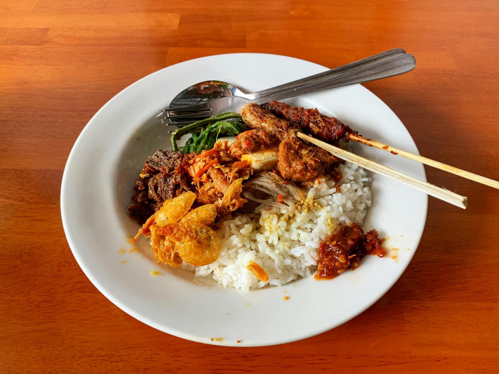 Traditional Balinese nasi campur plate with rice and side dishes