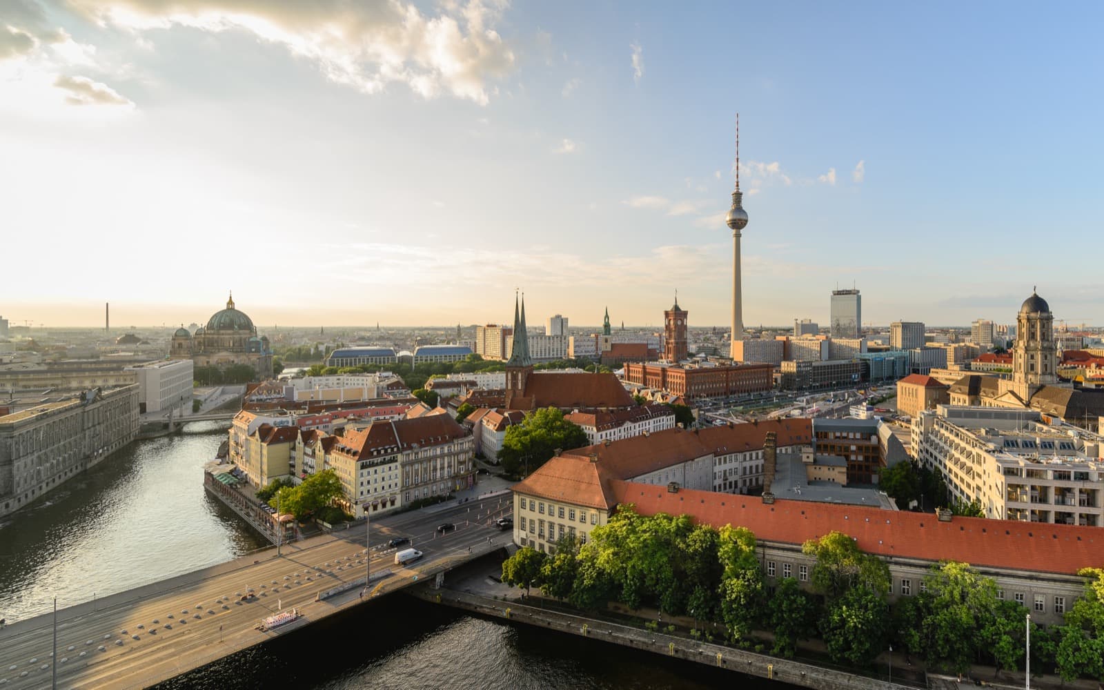 Central Berlin in warm-weather light with the Fernsehturm, Berliner Dom, and the Spree visible
