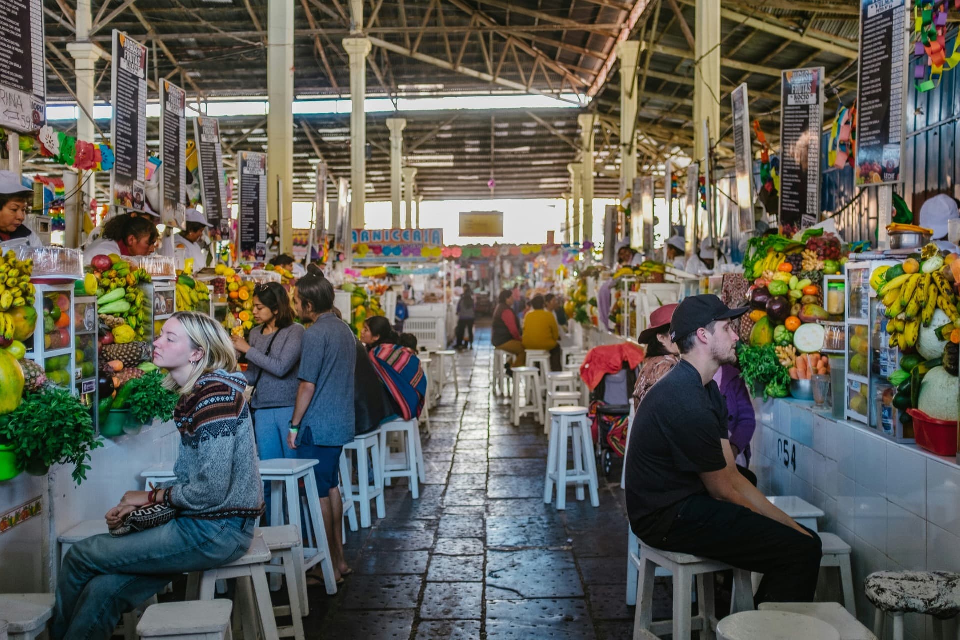 Food stalls and seating inside San Pedro Market in Cusco