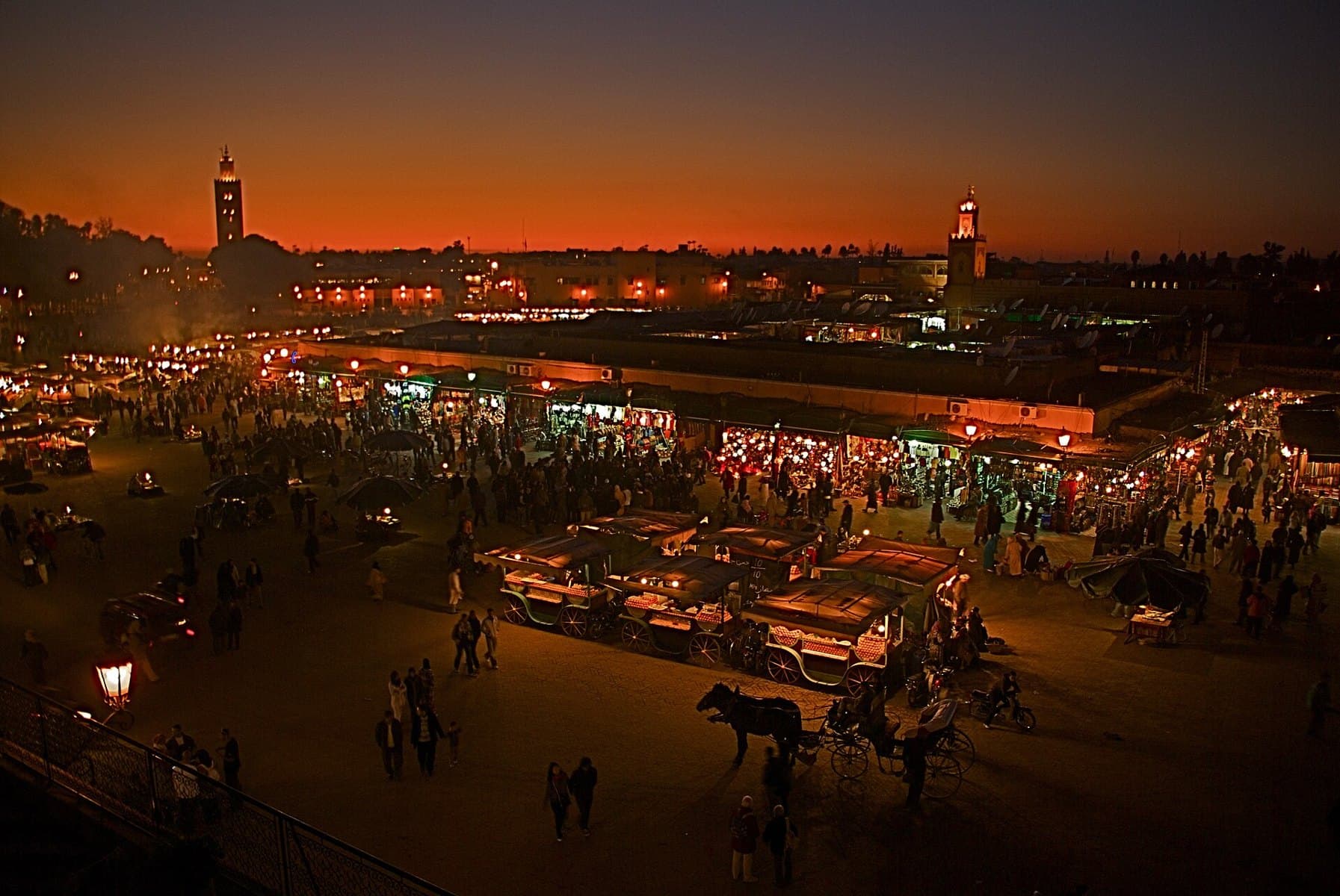 Jemaa el-Fnaa square at night with crowds and food stalls in Marrakech