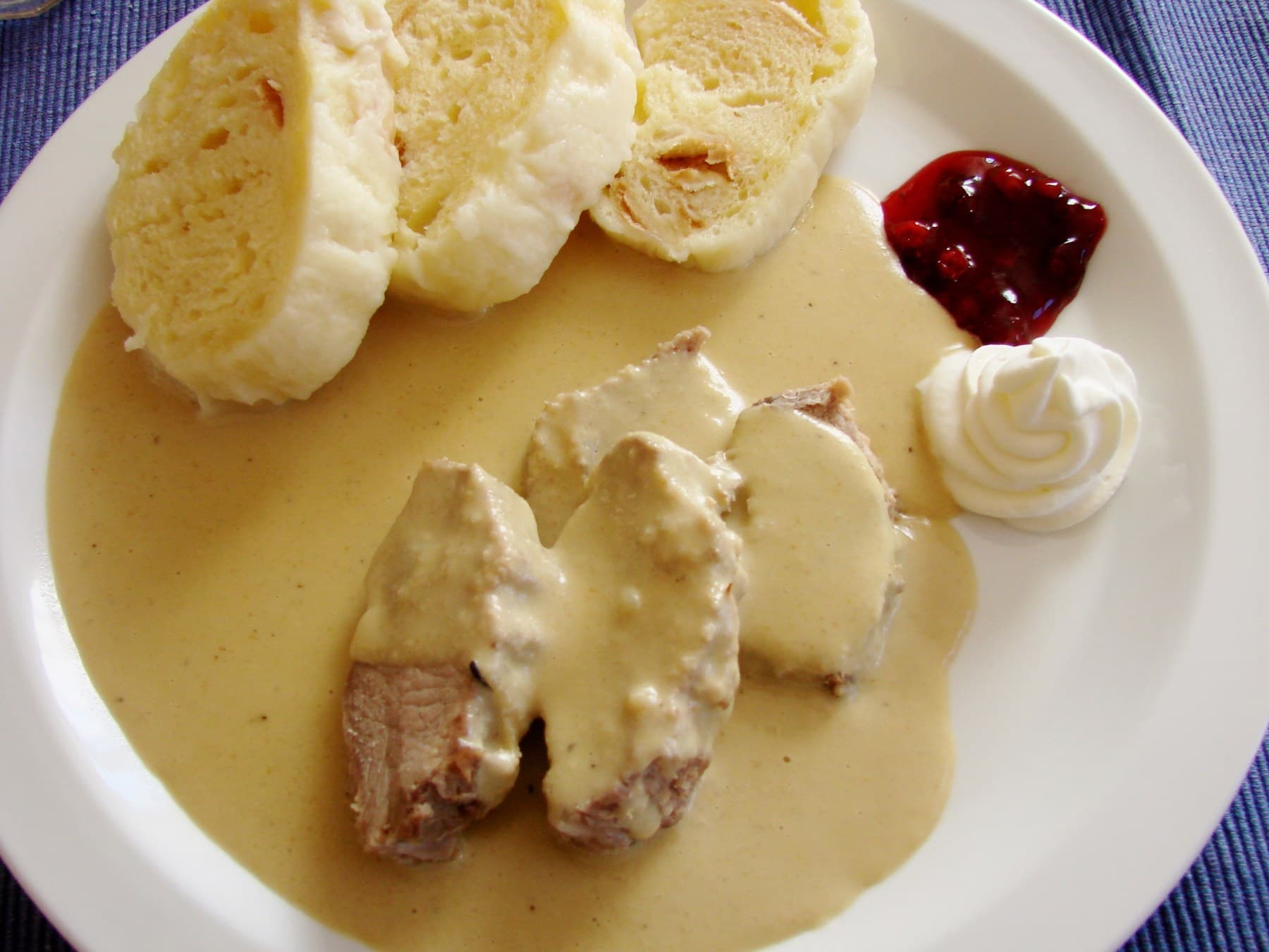 A plate of Czech svíčková with dumplings