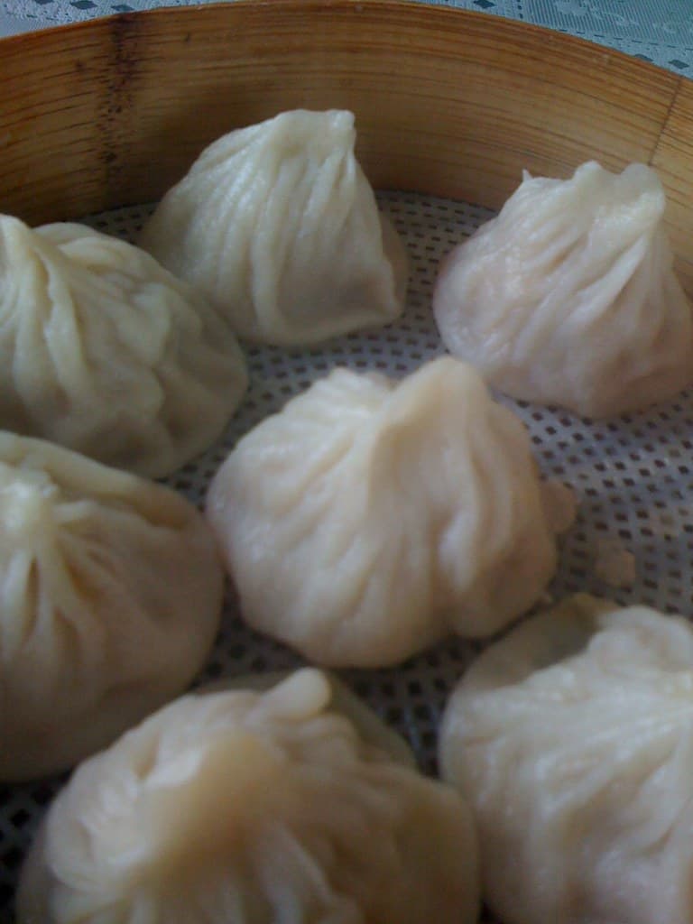 A basket of xiaolongbao soup dumplings.