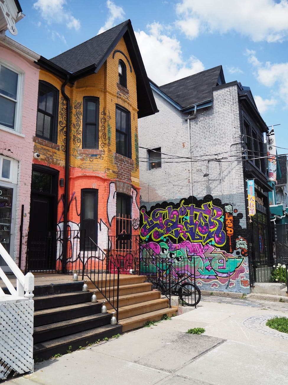 Colorful houses with vibrant graffiti and street art in Toronto's Kensington Market neighborhood