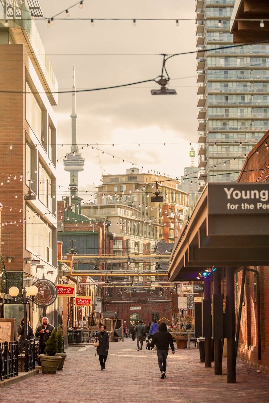 Vibrant Toronto street scene with pedestrians and the CN Tower visible in the background